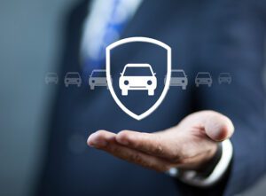 man holding a car in a shield graphic